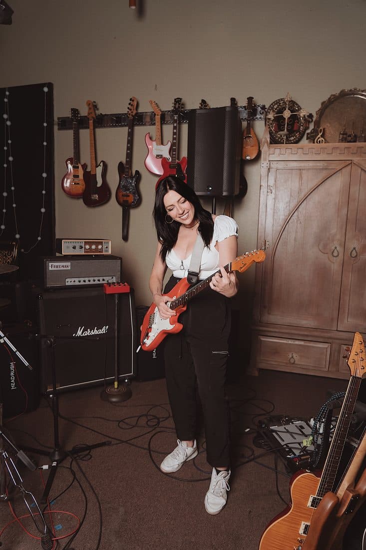 Cass with a guitar at Studio 77