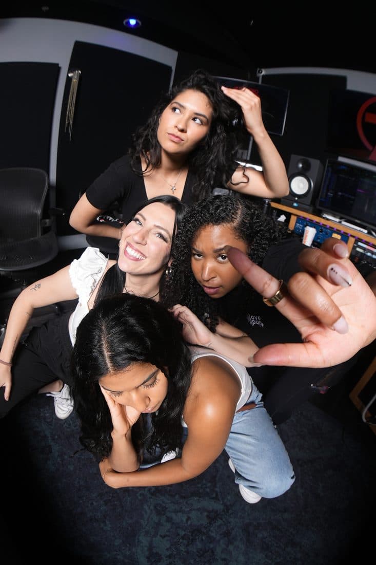 Four 2023 writers striking a pose at the board
